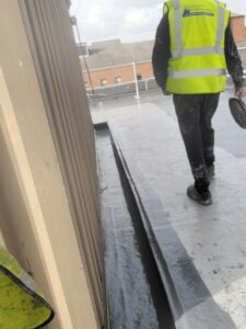 Lichfield Waterproofing employer working on a flat roof